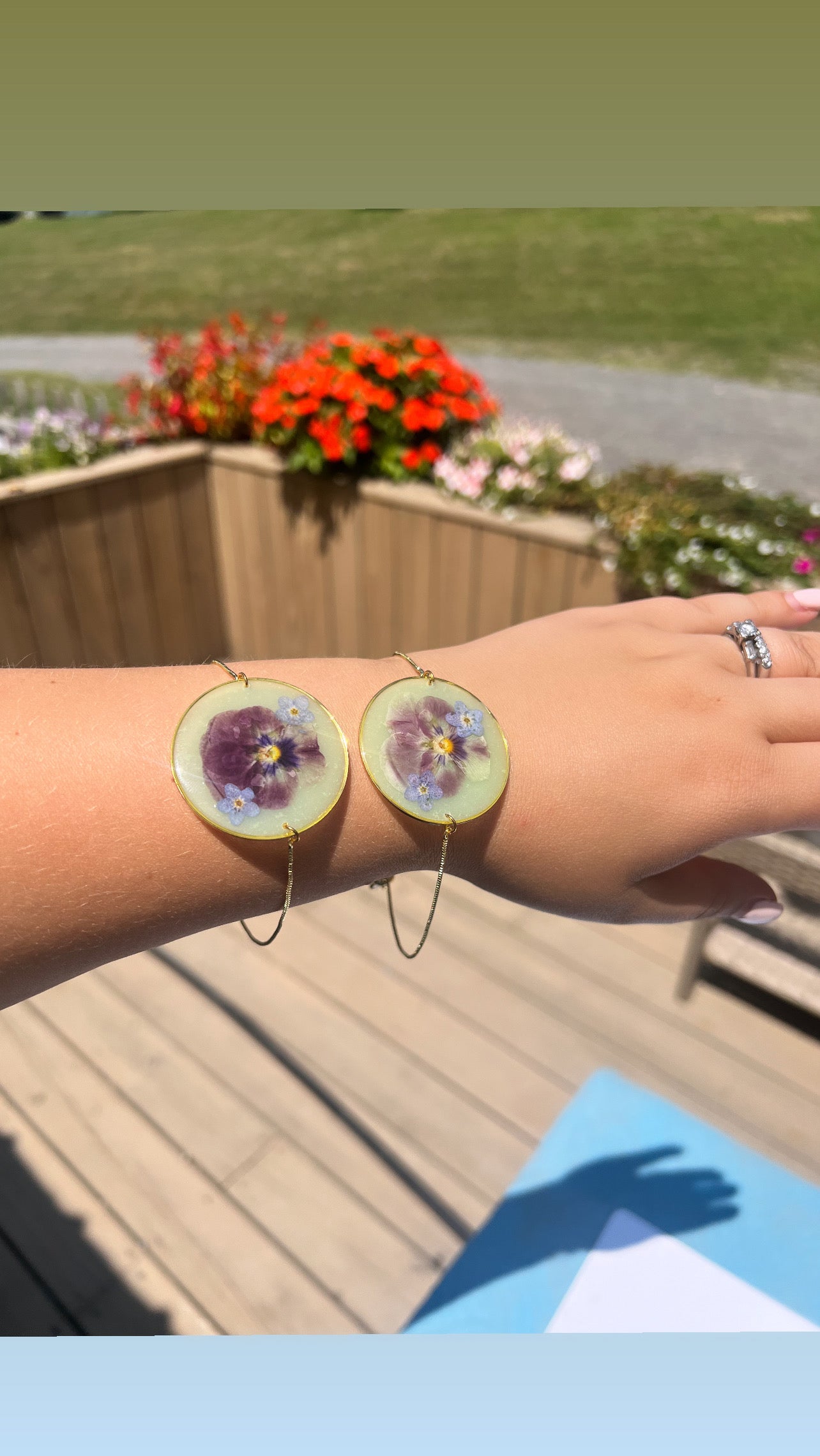 Pale green with pansies and forget me nots. Adjustable bracelets.