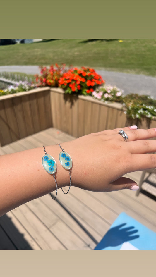 Pale green with forget me nots. Adjustable bracelets.