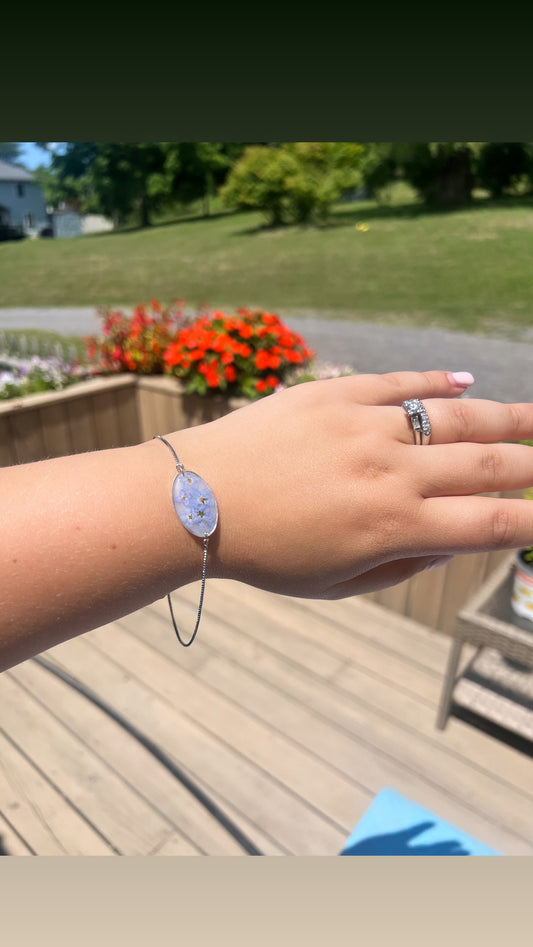 Pale blue with forget me nots. Silver color adjustable bracelet.￼